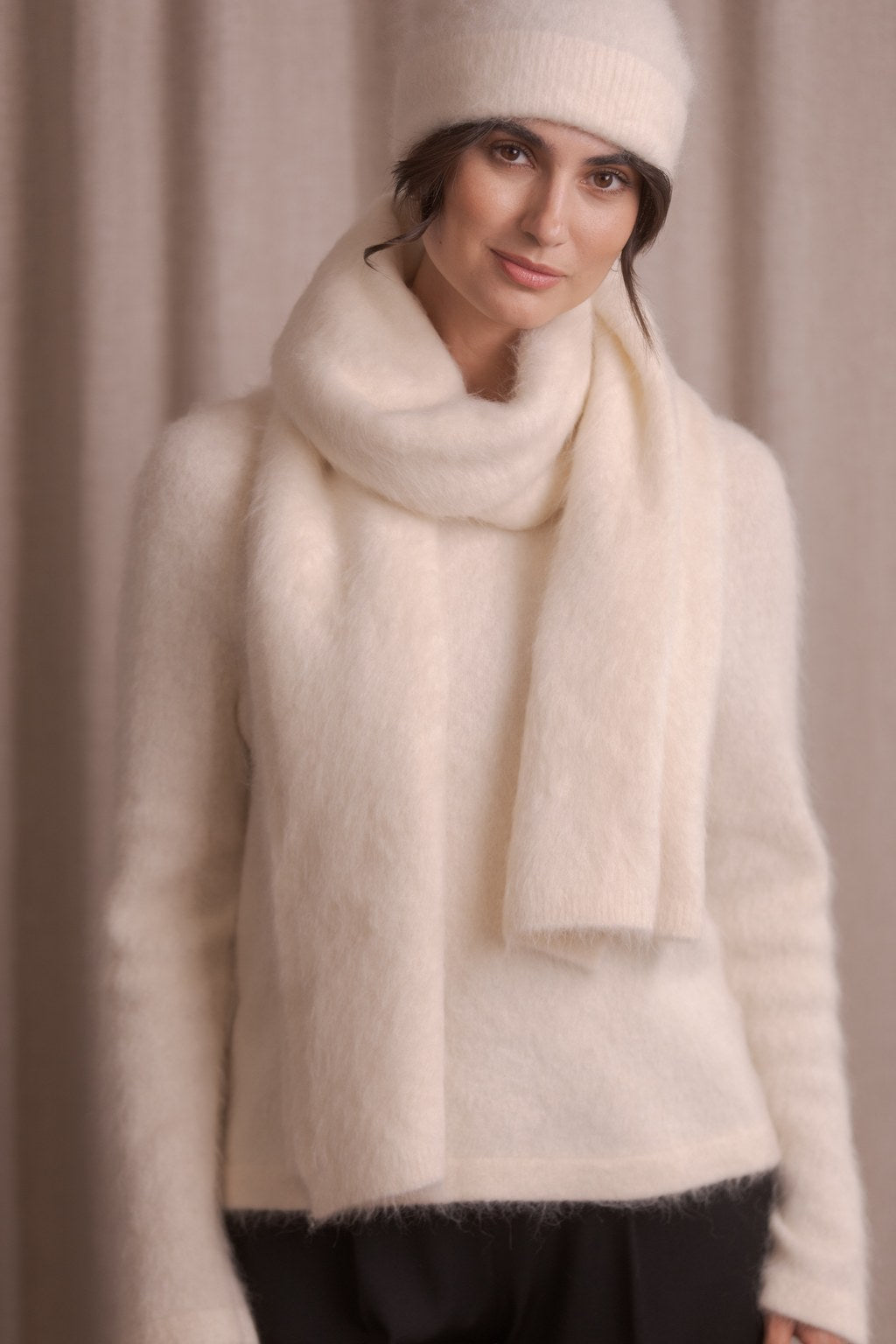Lähikuva naisesta, jolla Original Storyn alpakkasekoitehuivi sävyssä cream